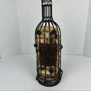 Wine bottle cork cage in metal filled with corks.